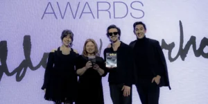 Abovo team members, Kristen Kjellberg, Jennifer Hicks, Tristan Pfaff, and Andrew Young, smiling and holding award trophies at the Regional American Advertising Federation awards ceremony.