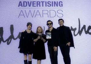 Abovo team members, Kristen Kjellberg, Jennifer Hicks, Tristan Pfaff, and Andrew Young, smiling and holding award trophies at the Regional American Advertising Federation awards ceremony.