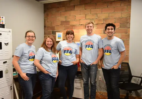 Abovo team wearing North Dakota FFA t-shirts designed for the annual state convention, smiling and standing together.